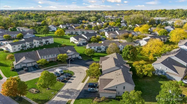an aerial view of residential houses with outdoor space