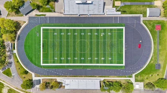 an aerial view of a golf course with a swimming pool