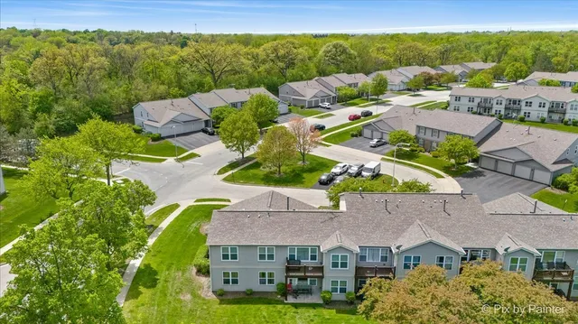 an aerial view of multiple houses with a yard