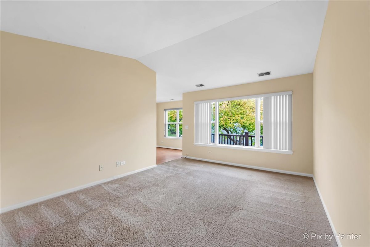 1023 Berkshire Court, Unit C Elgin, IL 60120 - Photo 9 of 54 an empty room with windows