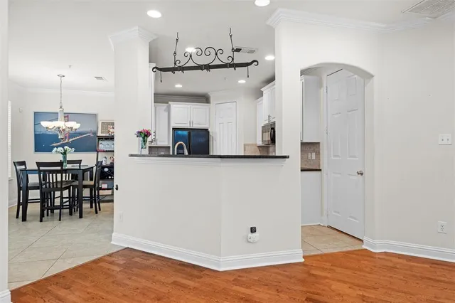 a view of a hallway with bedroom and workspace