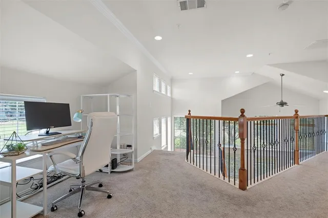 a view of a workspace with furniture and a window