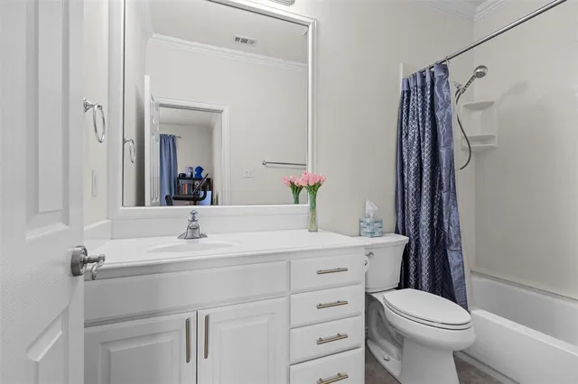 a bedroom with a bed painting and a large window