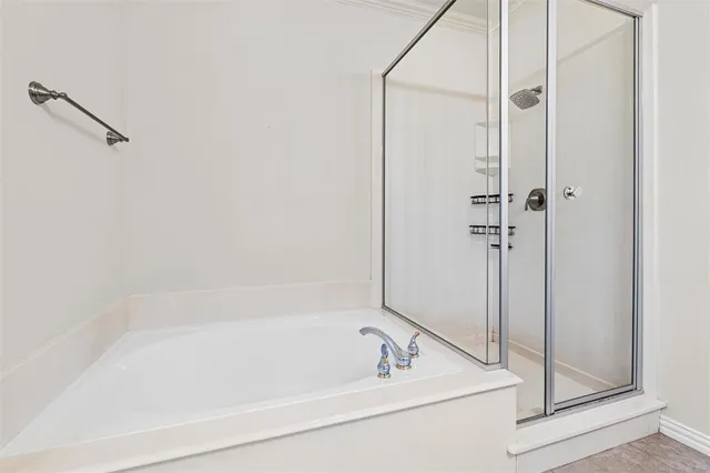 a view of a chair and table in the back yard of the house