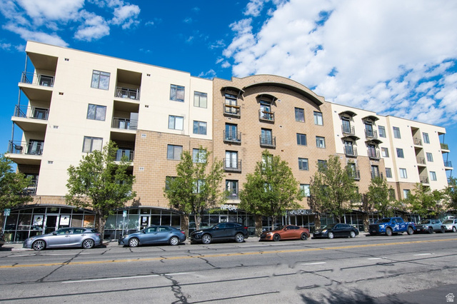 2150 South Main Street, Unit R405 Salt Lake City, UT 84115 - Photo 1 of 20 Multi-story building featuring a mixed-material facade with tan stucco and light brown brickwork