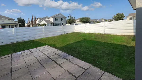 a view of a backyard with potted plants