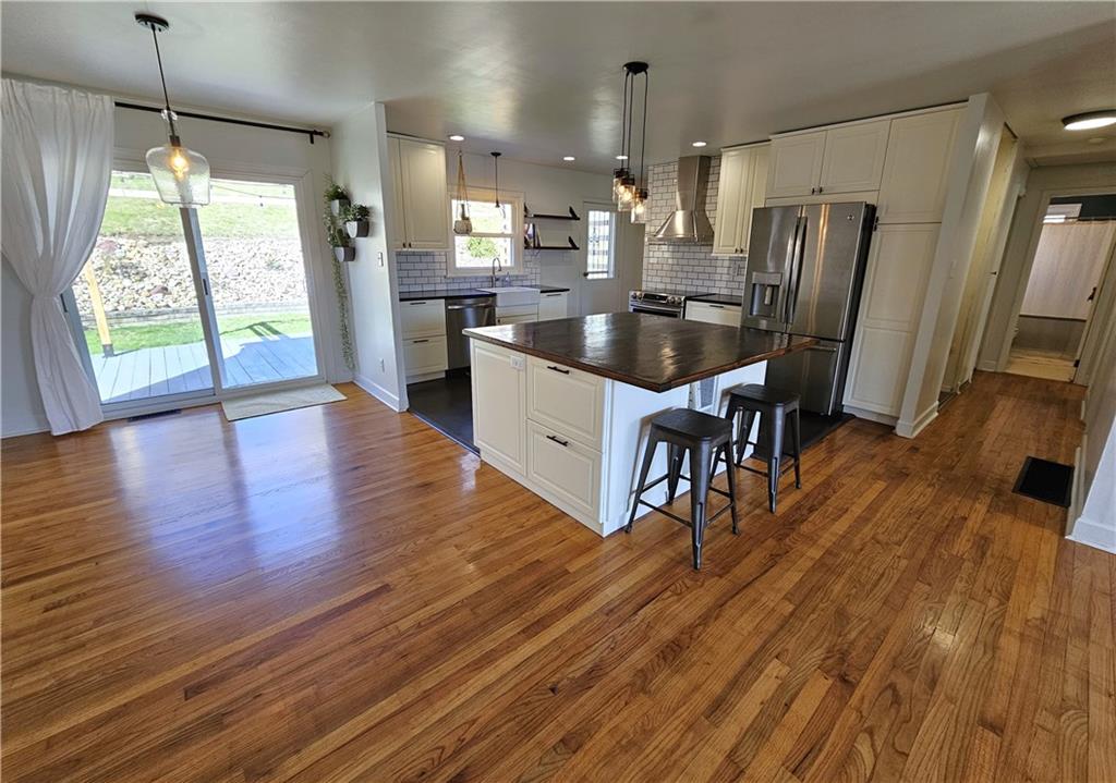 57 Old York Road Washington, PA 15301 - Photo 4 of 25 a kitchen with stainless steel appliances granite countertop wooden floors refrigerator and window