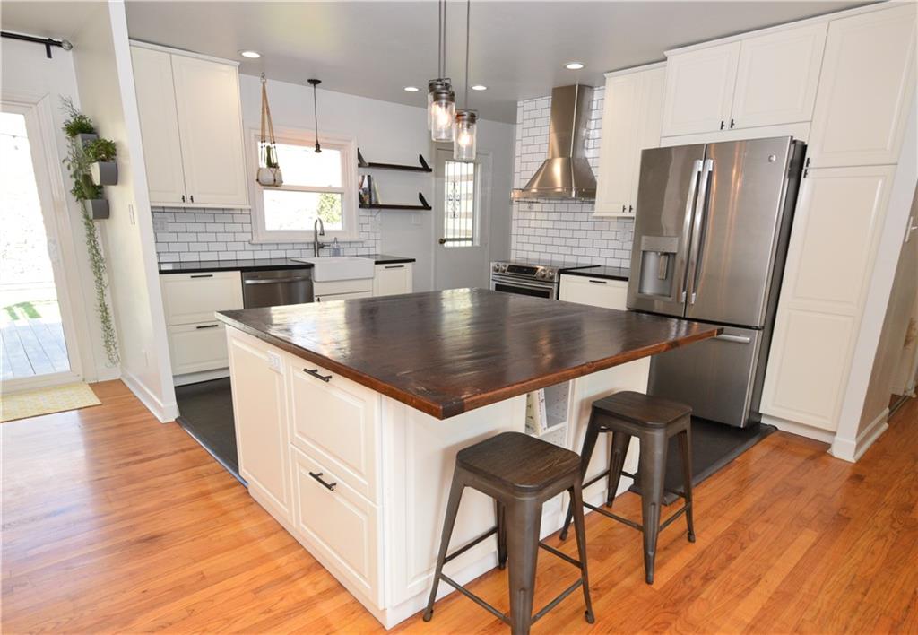 57 Old York Road Washington, PA 15301 - Photo 6 of 25 a kitchen with stainless steel appliances granite countertop a refrigerator a sink a stove a dining table and chairs