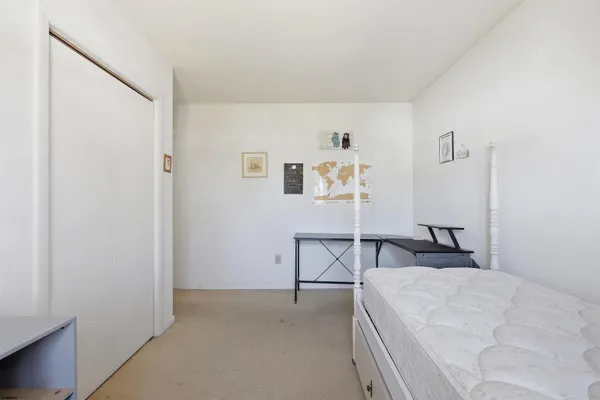 a bedroom with a bed and a table in it