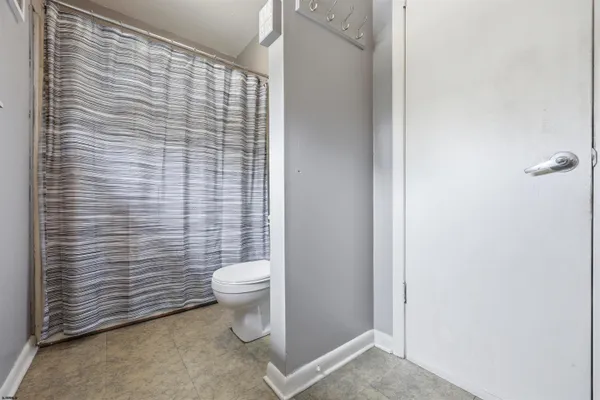 a bathroom with a toilet and a shower