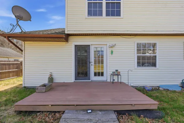 a backyard of a house with barbeque oven table and chairs