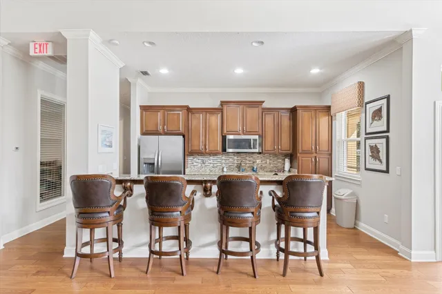 a room with a table chairs and a chandelier
