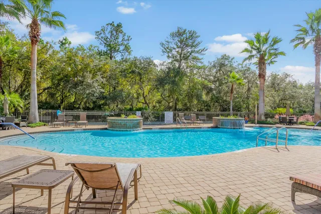 a view of a swimming pool with a patio