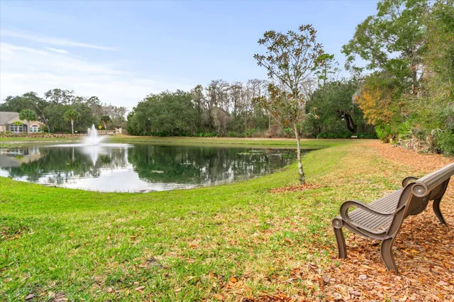 a view of a lake with couches and wooden fence