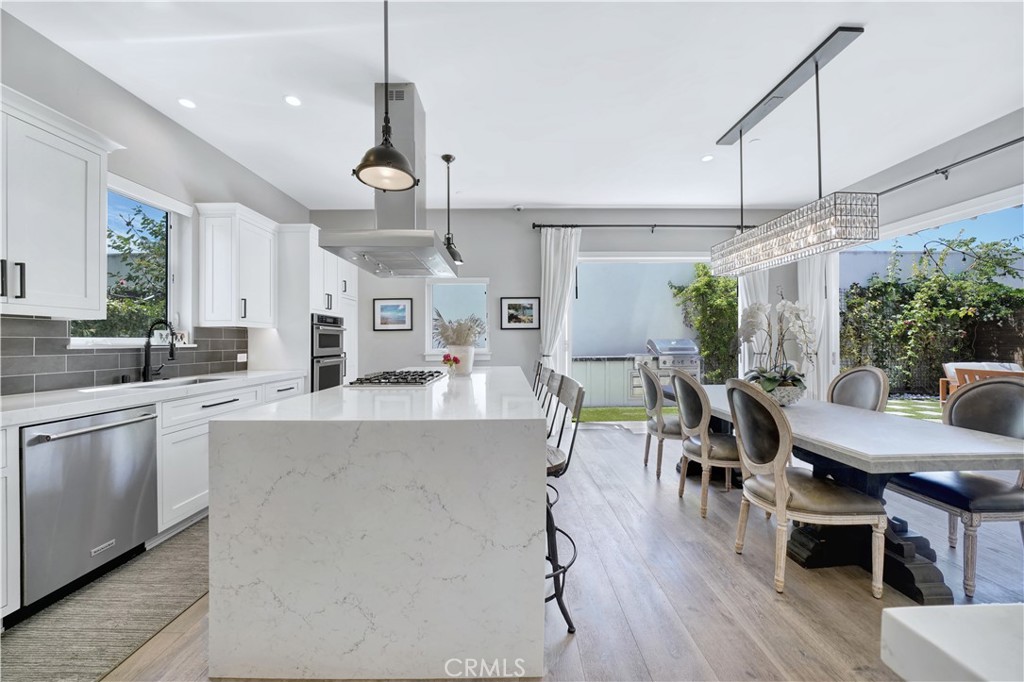 a large kitchen with a table and chairs