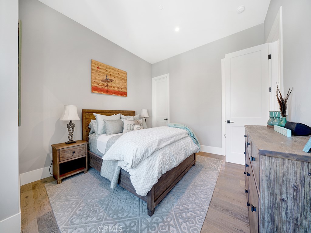 169 22nd Street Costa Mesa, CA 92627 - Photo 11 of 22 a bedroom with a bed and a flat screen tv