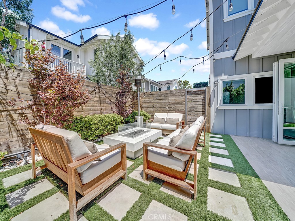 169 22nd Street Costa Mesa, CA 92627 - Photo 17 of 22 a view of a patio with table and chairs with wooden floor and fence