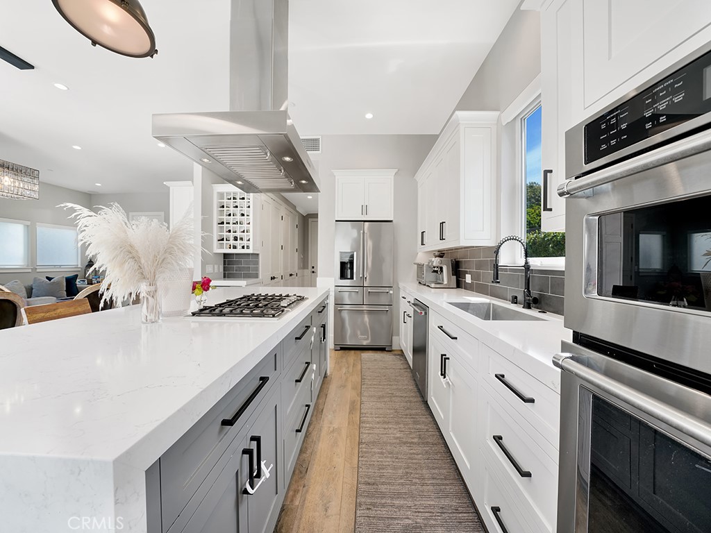 169 22nd Street Costa Mesa, CA 92627 - Photo 4 of 22 a large white kitchen with a stove and a sink
