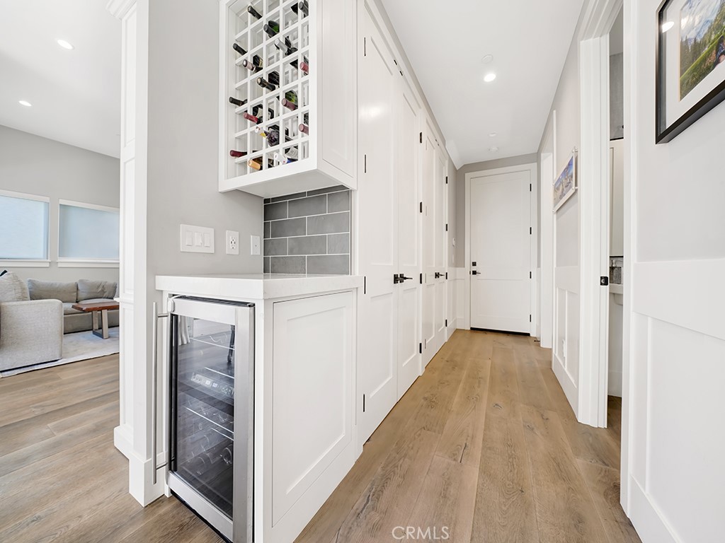 169 22nd Street Costa Mesa, CA 92627 - Photo 7 of 22 a view of a hallway with wooden floor and living room