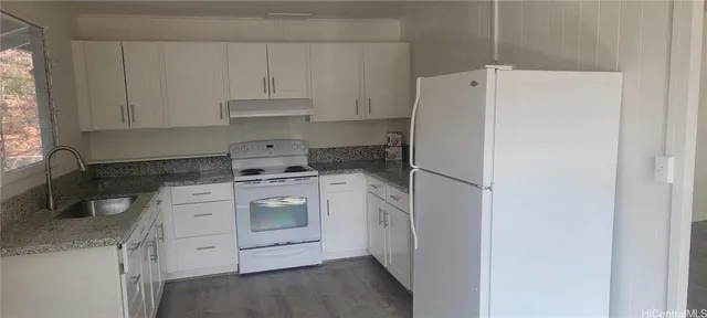 a kitchen with a stove and a refrigerator