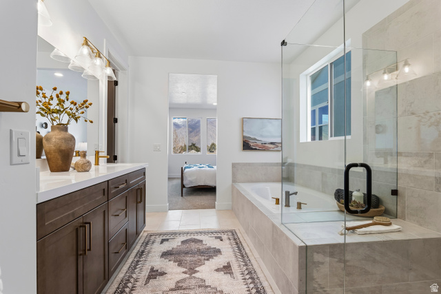 624 North Legend Circle, Unit 480 Mapleton, UT 84664 - Photo 27 of 34 Full bath featuring double vanity, connected bathroom, a shower stall, a garden tub, and light tile patterned flooring