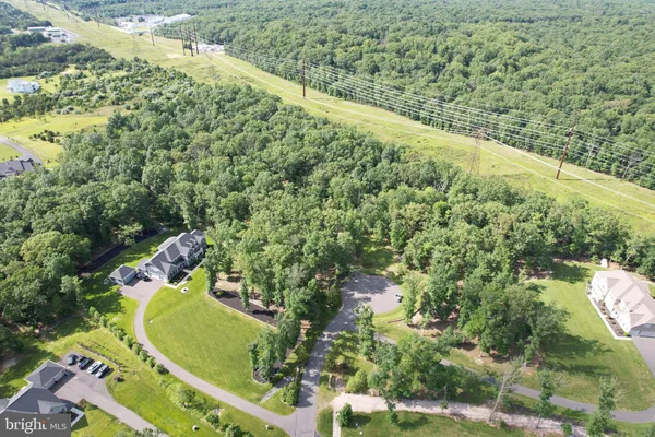 an aerial view of residential houses with outdoor space and ocean view