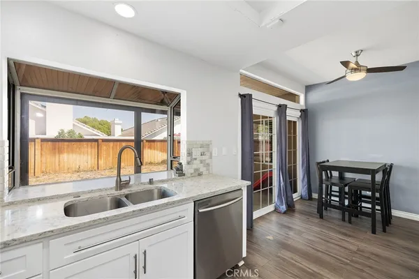 a bathroom with a sink vanity mirror and toilet