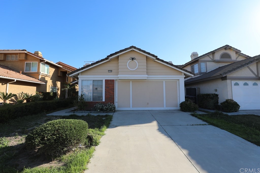 15549 Old Castle Road Fontana, CA 92337 - Photo 1 of 1 a front view of a house with a yard and garage