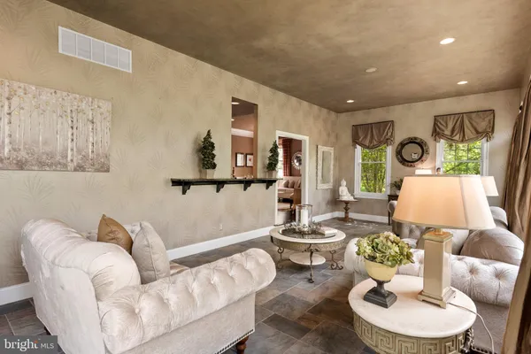 a kitchen with stainless steel appliances granite countertop a refrigerator a sink dishwasher a stove with white cabinets and wooden floor