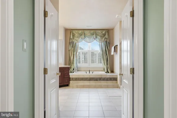 a view of a living room a dining room wooden floor and a window