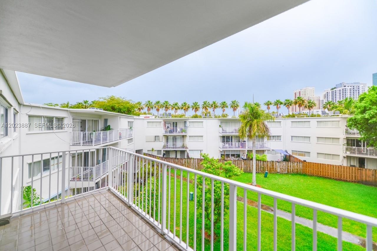 7737 Southwest 88th Street, Unit C312 Miami, FL 33156 - Photo 1 of 32 a view of a house with a yard and sitting area