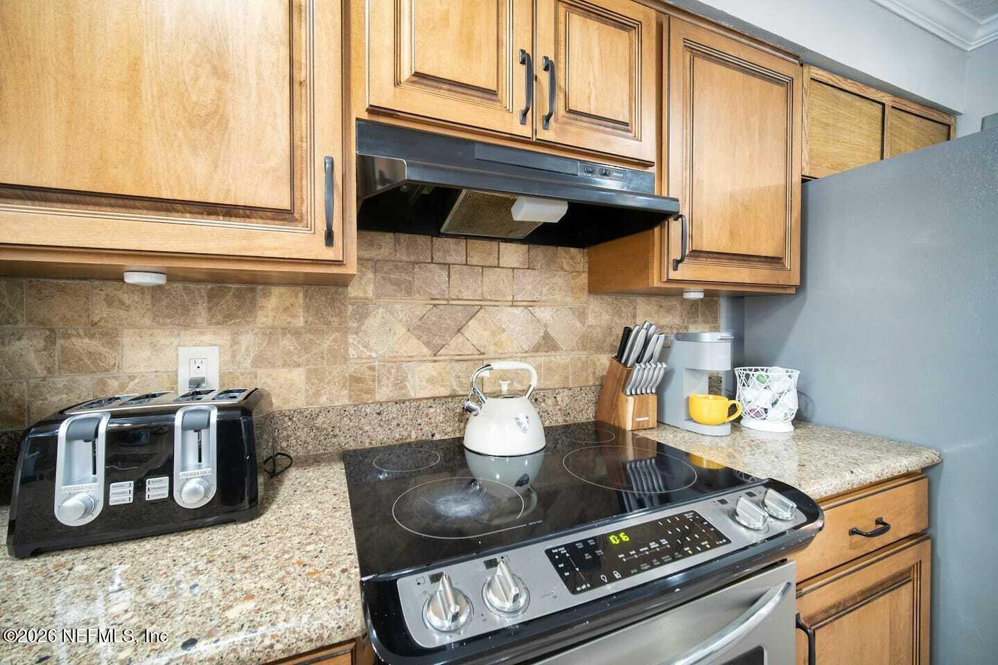 11613 Lake Ride Drive Jacksonville, FL 32223 - Photo 22 of 42 a kitchen with a stove and a microwave