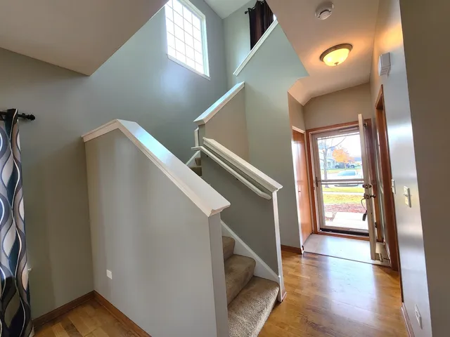 a view of entryway and hall with wooden floor