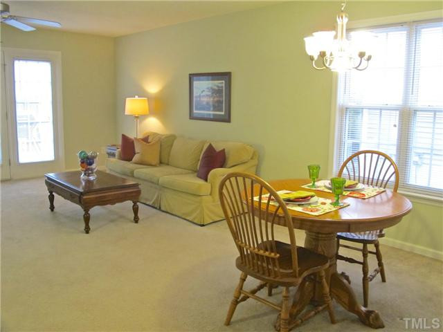 2300 Turtle Point Drive Raleigh, NC 27604 - Photo 17 of 25 Another view of the living/dining combo. The living room boasts two long walls for great furniture placement and additional focal points. A double window in the dining room and the French doors at the deck just fill the space with natural light. Living Room