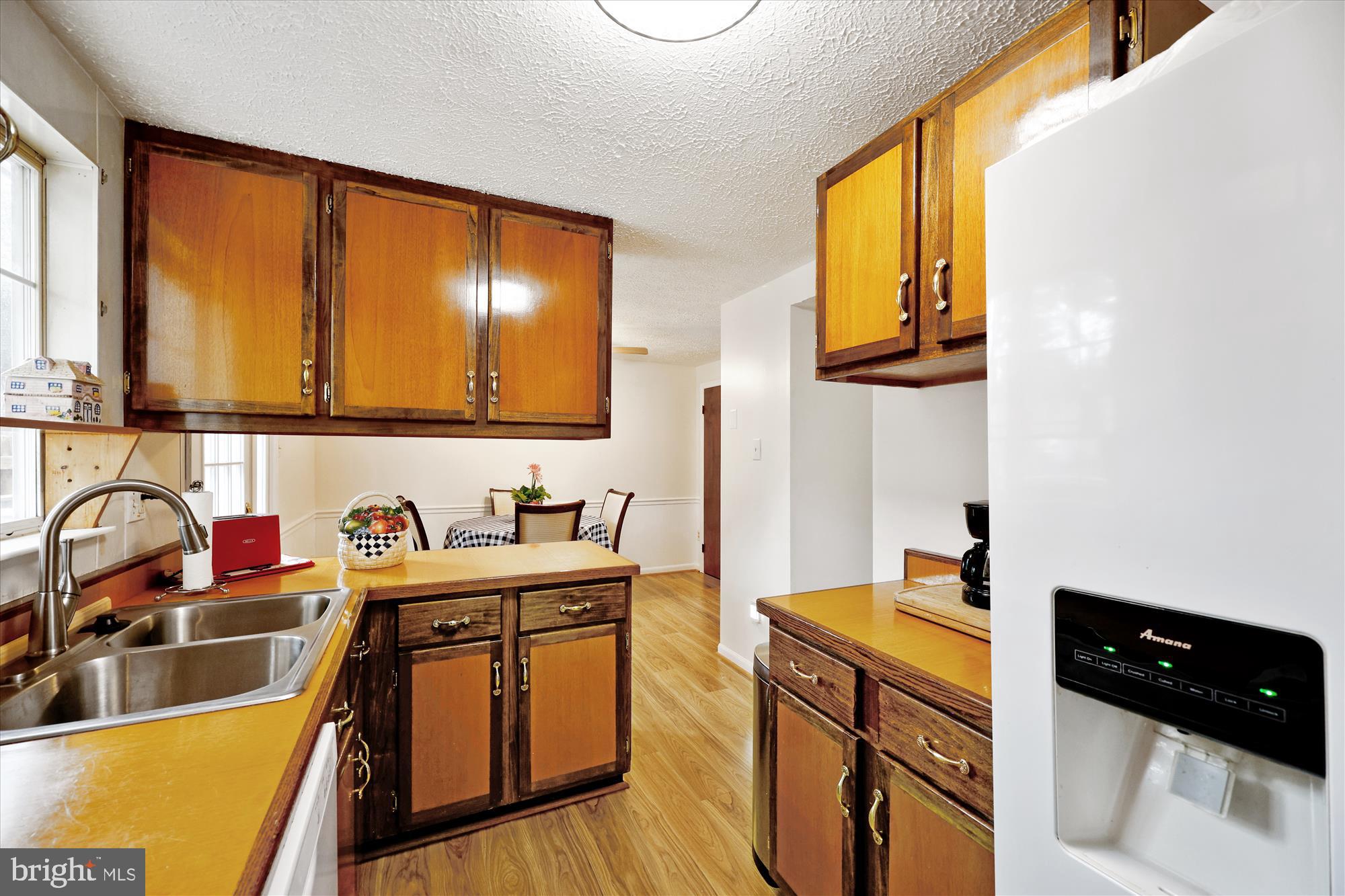 25510 Coltrane Drive Damascus, MD 20872 - Photo 11 of 50 a kitchen with a sink stove and cabinets