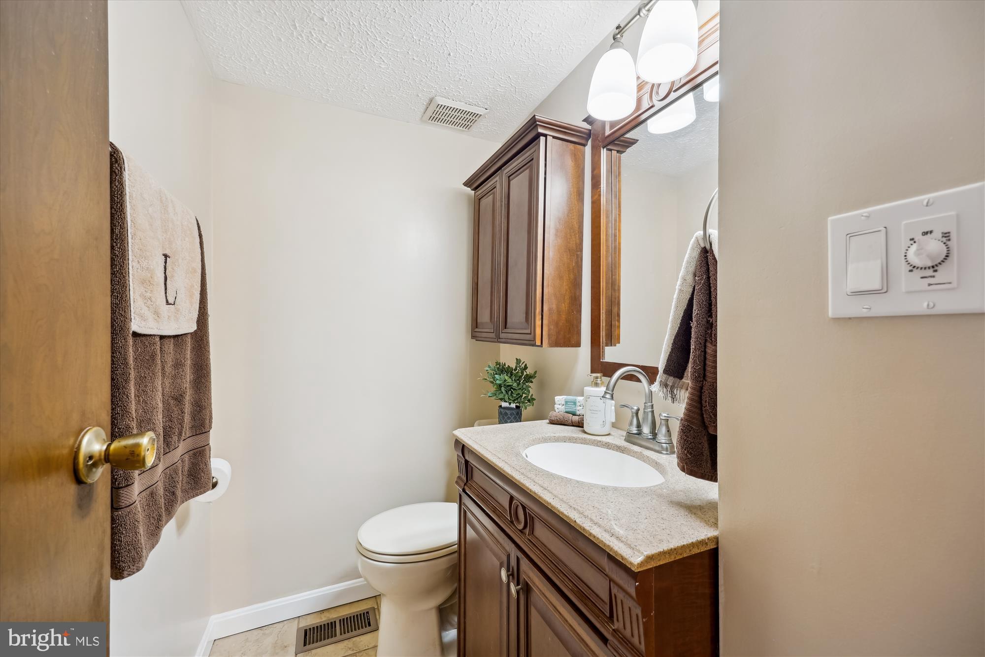 25510 Coltrane Drive Damascus, MD 20872 - Photo 12 of 50 a bathroom with a sink toilet and a mirror