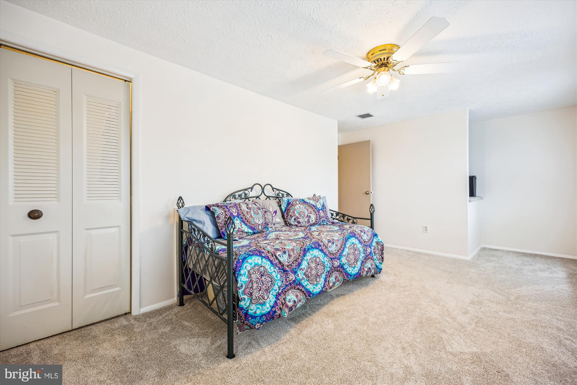 25510 Coltrane Drive Damascus, MD 20872 - Photo 14 of 50 a bedroom with a bed and a chandelier fan