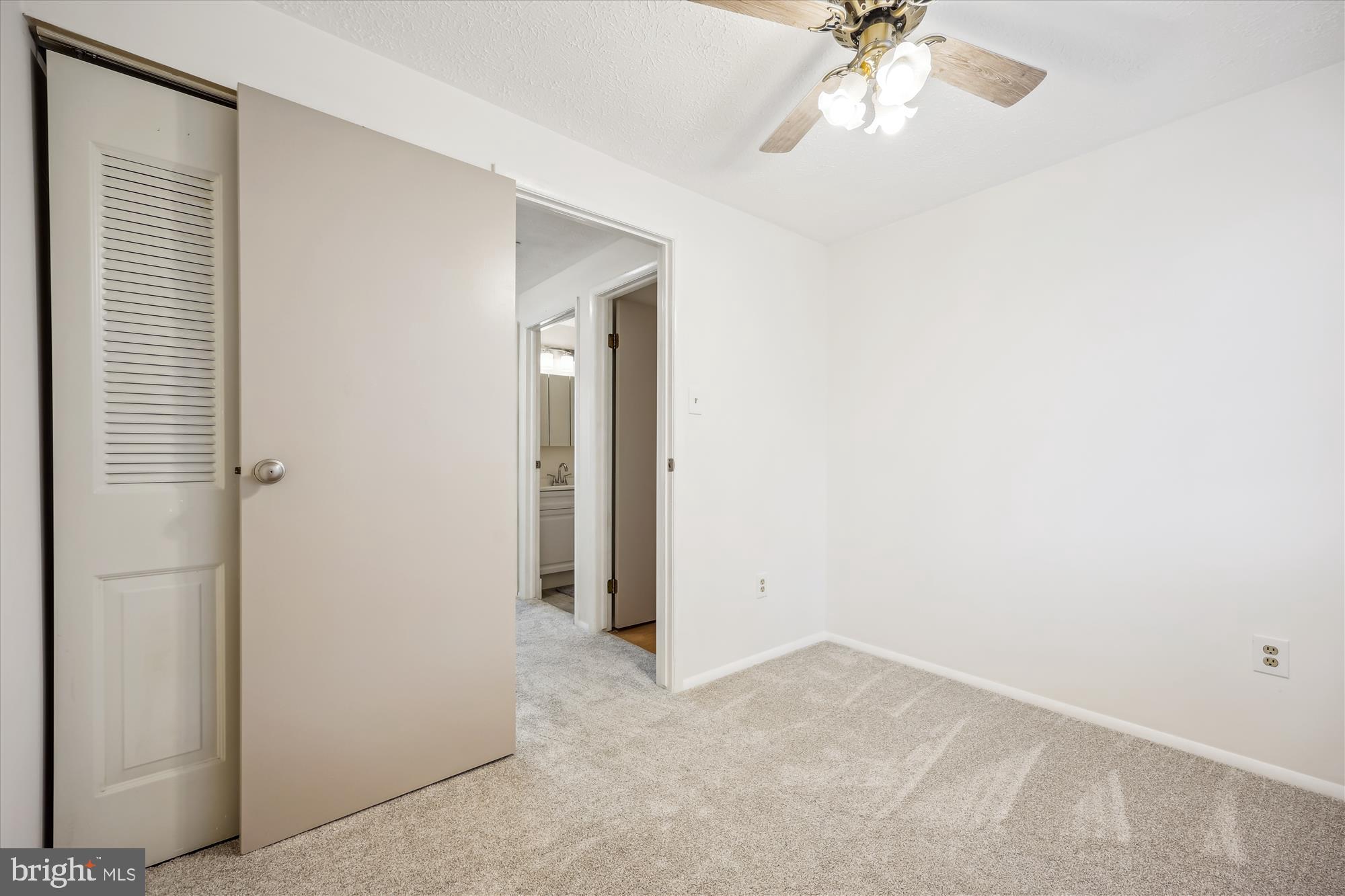 25510 Coltrane Drive Damascus, MD 20872 - Photo 18 of 50 an empty room with a chandelier fan and windows