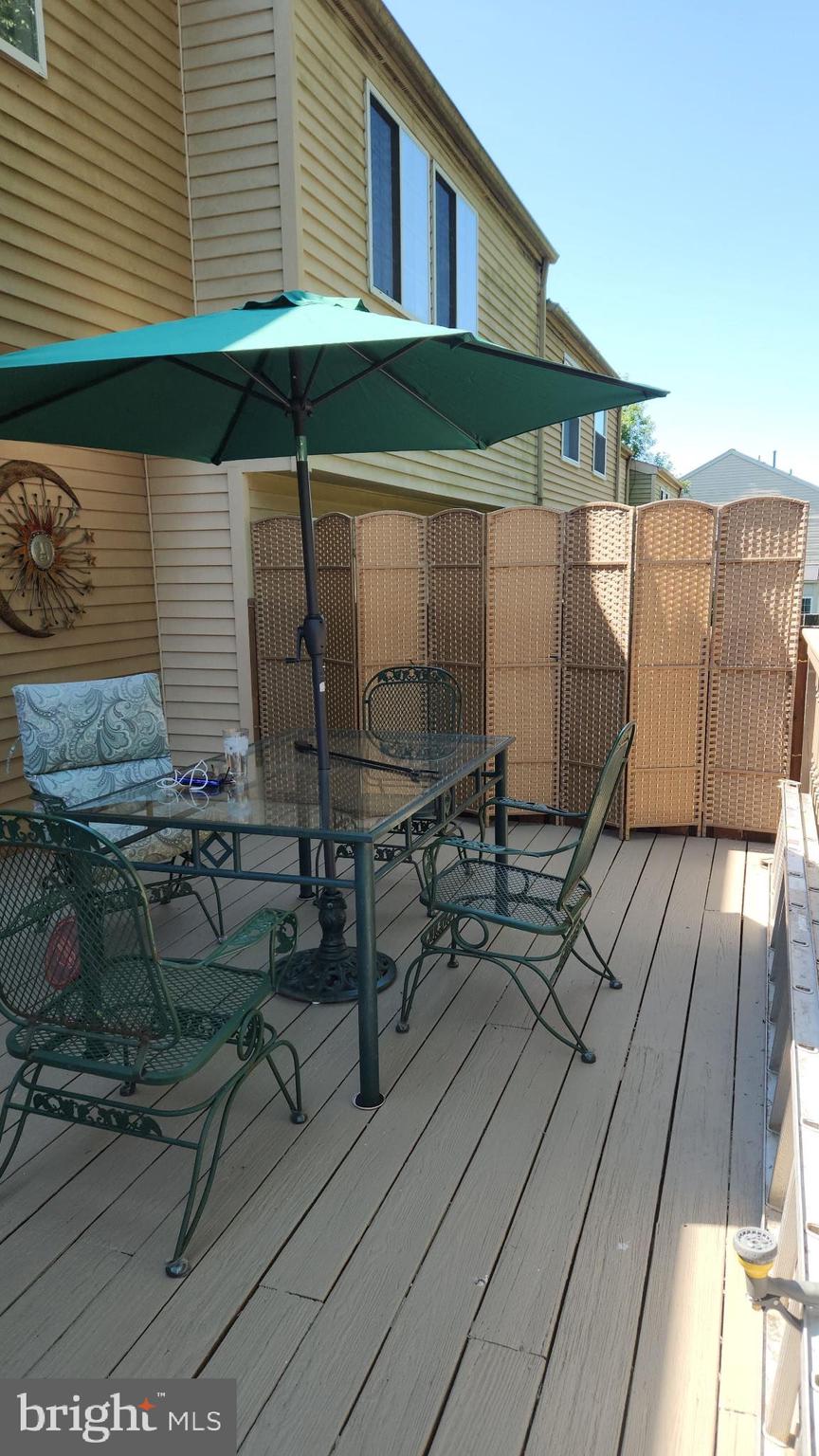 25510 Coltrane Drive Damascus, MD 20872 - Photo 27 of 50 a balcony with table and chairs