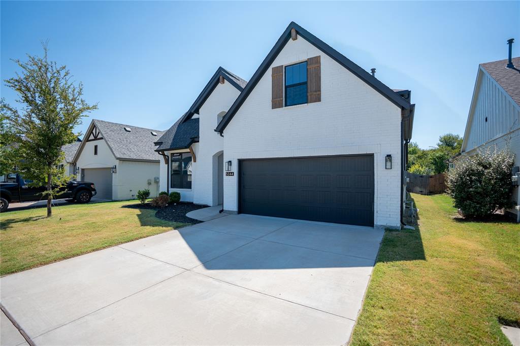 5244 Ranchero Trail Fort Worth, TX 76126 - Photo 2 of 33 View of front facade with brick siding, a front yard, driveway, and a garage
