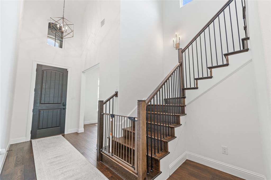 5244 Ranchero Trail Fort Worth, TX 76126 - Photo 21 of 33 Entrance foyer featuring a high ceiling, dark wood-style floors, and stairway