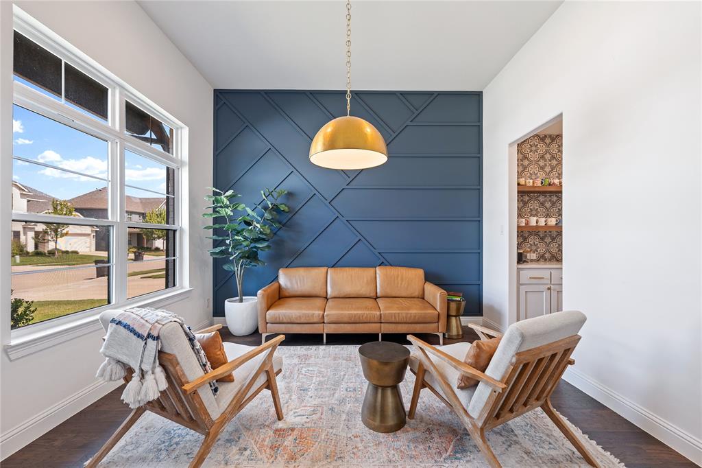 5244 Ranchero Trail Fort Worth, TX 76126 - Photo 3 of 33 Living area with an accent wall and wood finished floors
