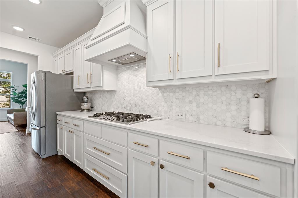5244 Ranchero Trail Fort Worth, TX 76126 - Photo 9 of 33 Kitchen featuring white cabinetry, tasteful backsplash, stainless steel appliances, dark wood-style floors, and custom exhaust hood