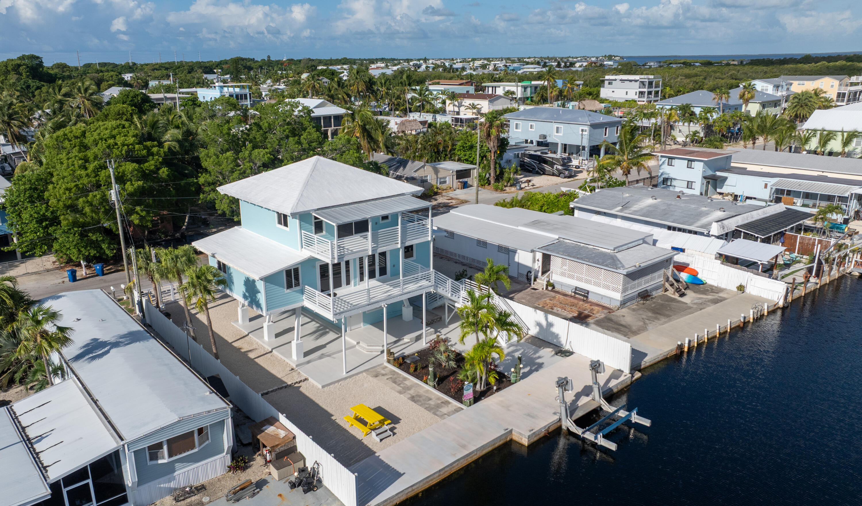 415 Big Pine Road Key Largo, FL 33037 - Photo 2 of 35 an aerial view of a house with a swimming pool patio and outdoor seating