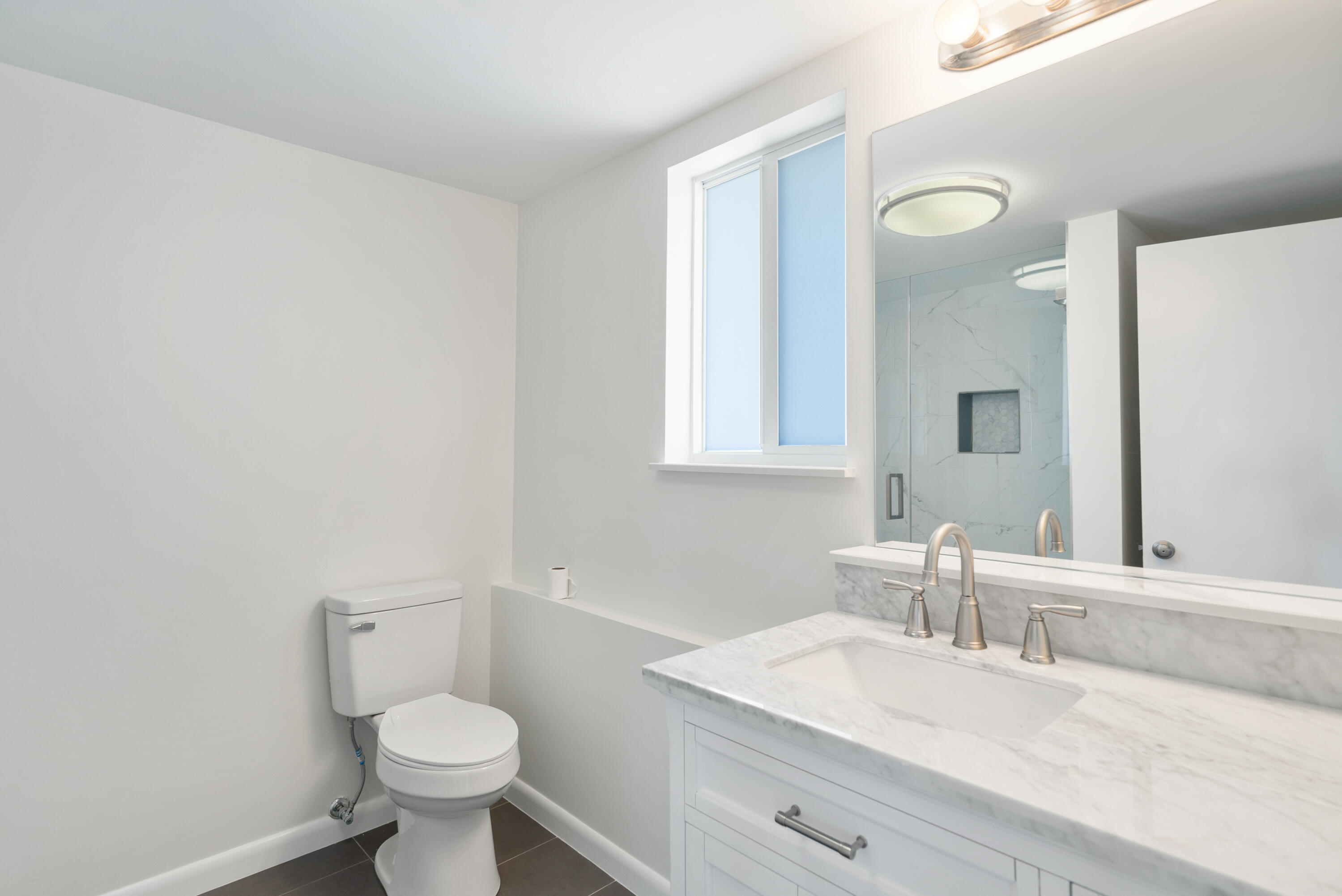 415 Big Pine Road Key Largo, FL 33037 - Photo 23 of 35 a bathroom with a sink toilet a mirror and vanity