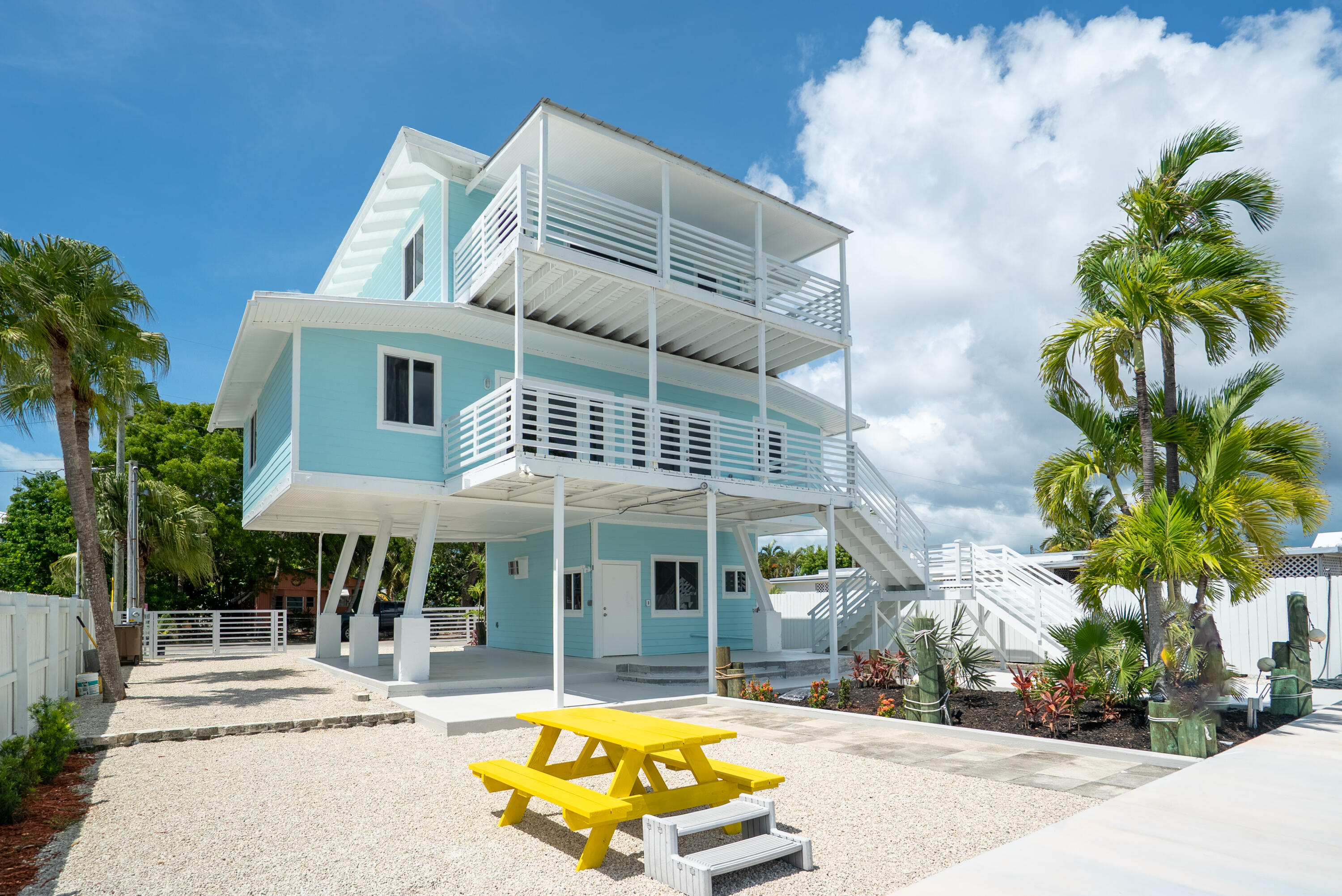 415 Big Pine Road Key Largo, FL 33037 - Photo 30 of 35 a view of a white house with a swimming pool