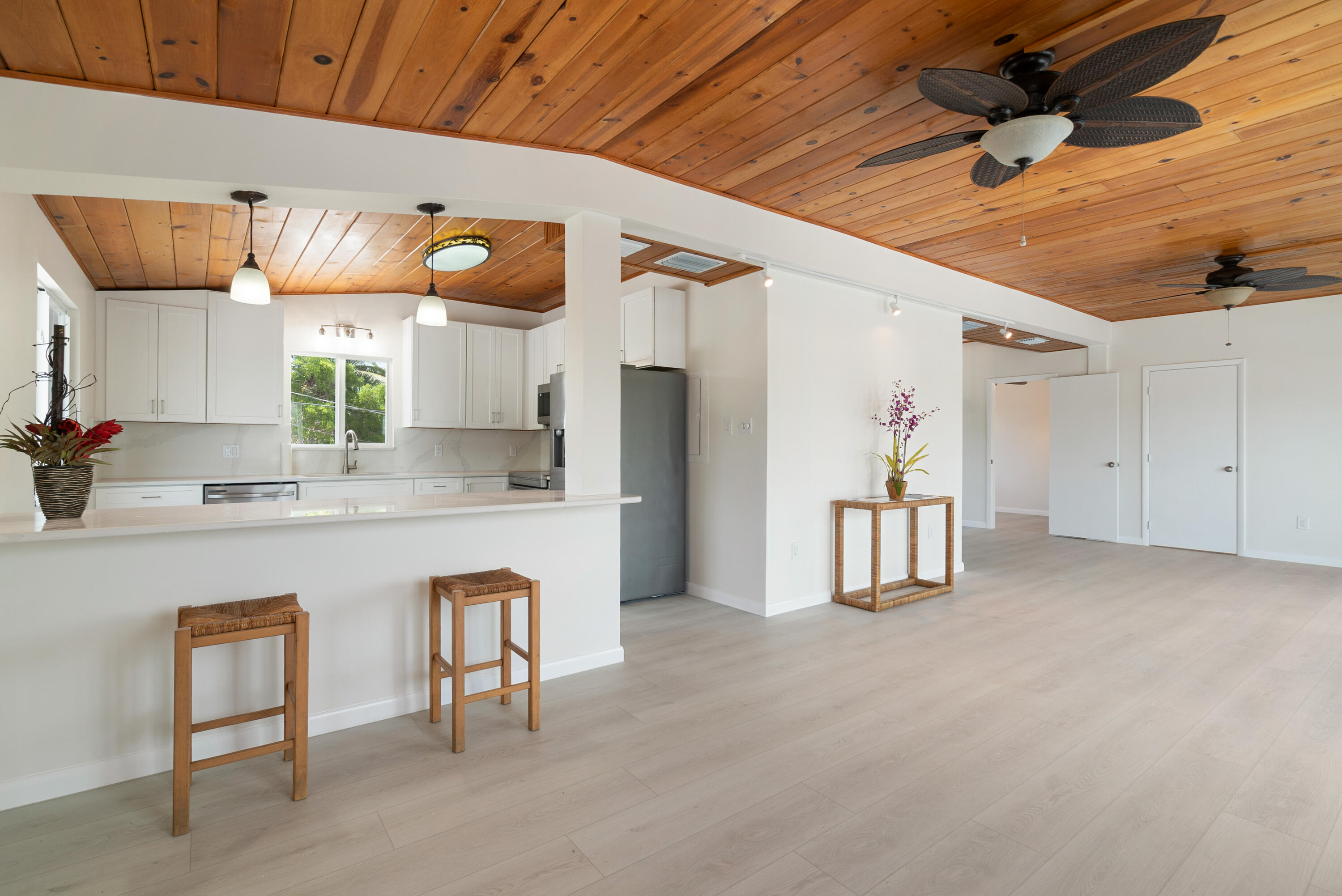 415 Big Pine Road Key Largo, FL 33037 - Photo 7 of 35 a kitchen with stainless steel appliances granite countertop a sink cabinets and wooden floor