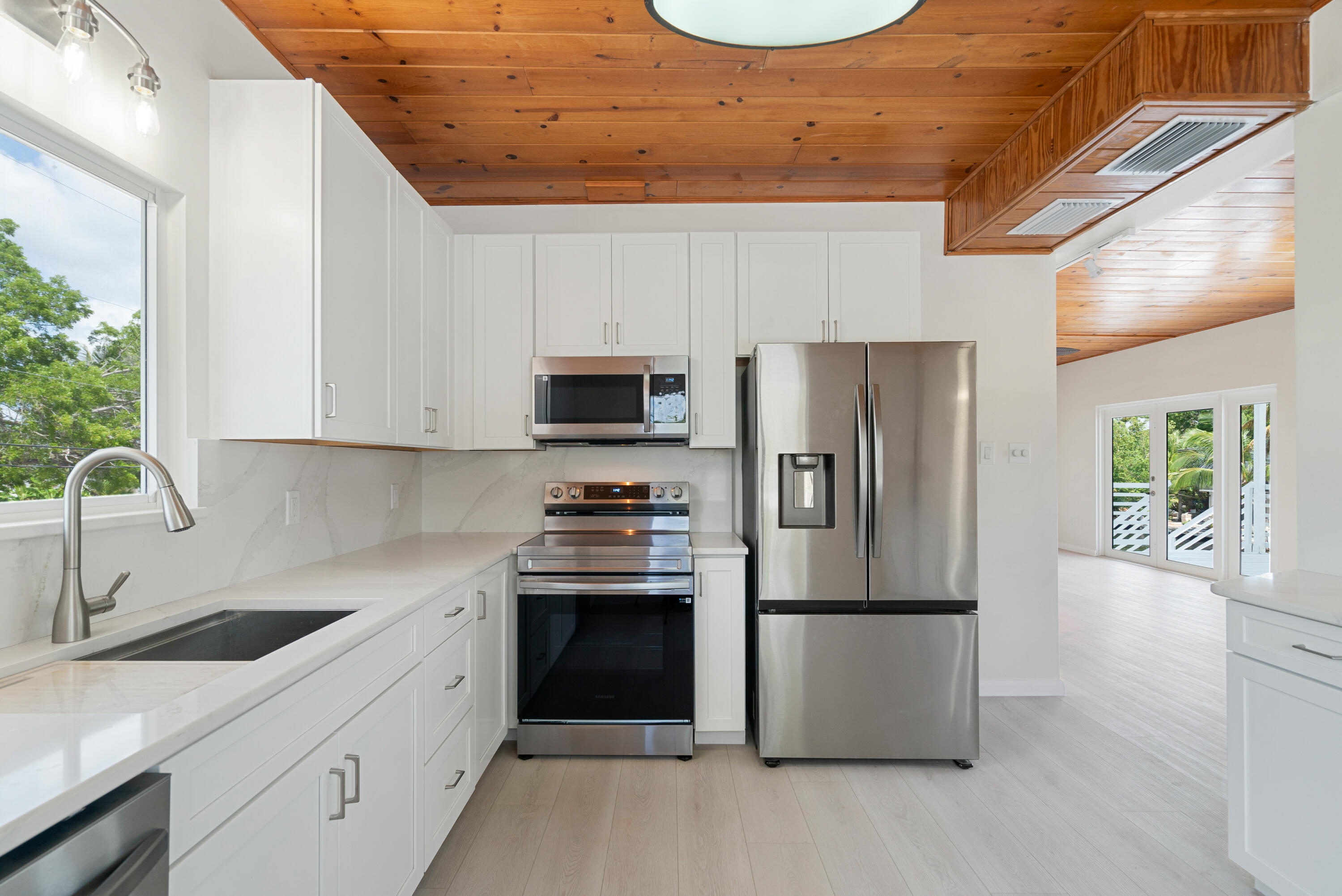 415 Big Pine Road Key Largo, FL 33037 - Photo 9 of 35 a kitchen with stainless steel appliances granite countertop a refrigerator sink and stove
