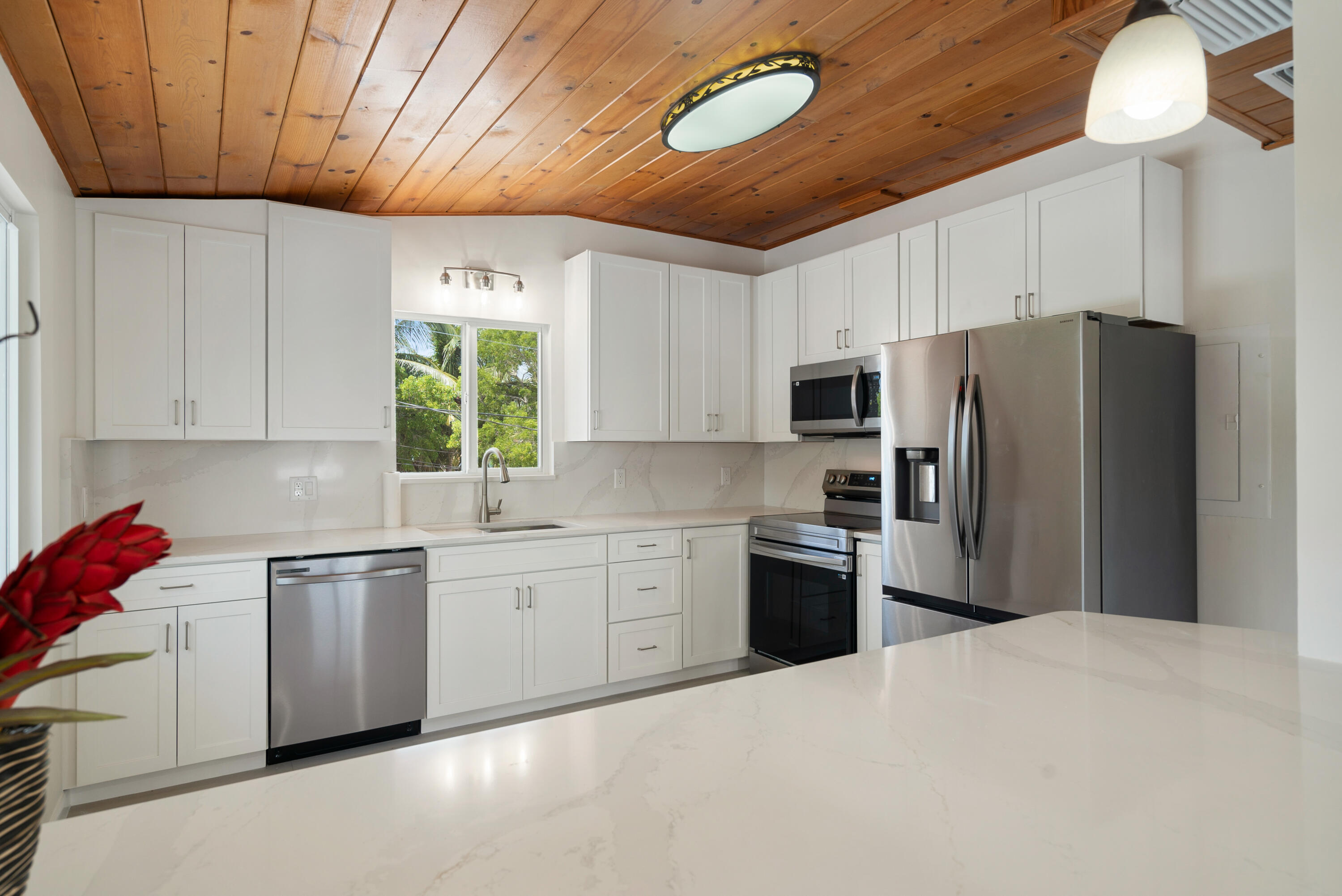 415 Big Pine Road Key Largo, FL 33037 - Photo 10 of 35 a kitchen with stainless steel appliances granite countertop a refrigerator a stove a sink dishwasher and a microwave