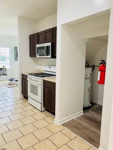 a kitchen with stainless steel appliances granite countertop a stove top oven and sink